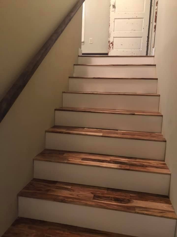 A set of stairs with wooden steps and white steps in a house.