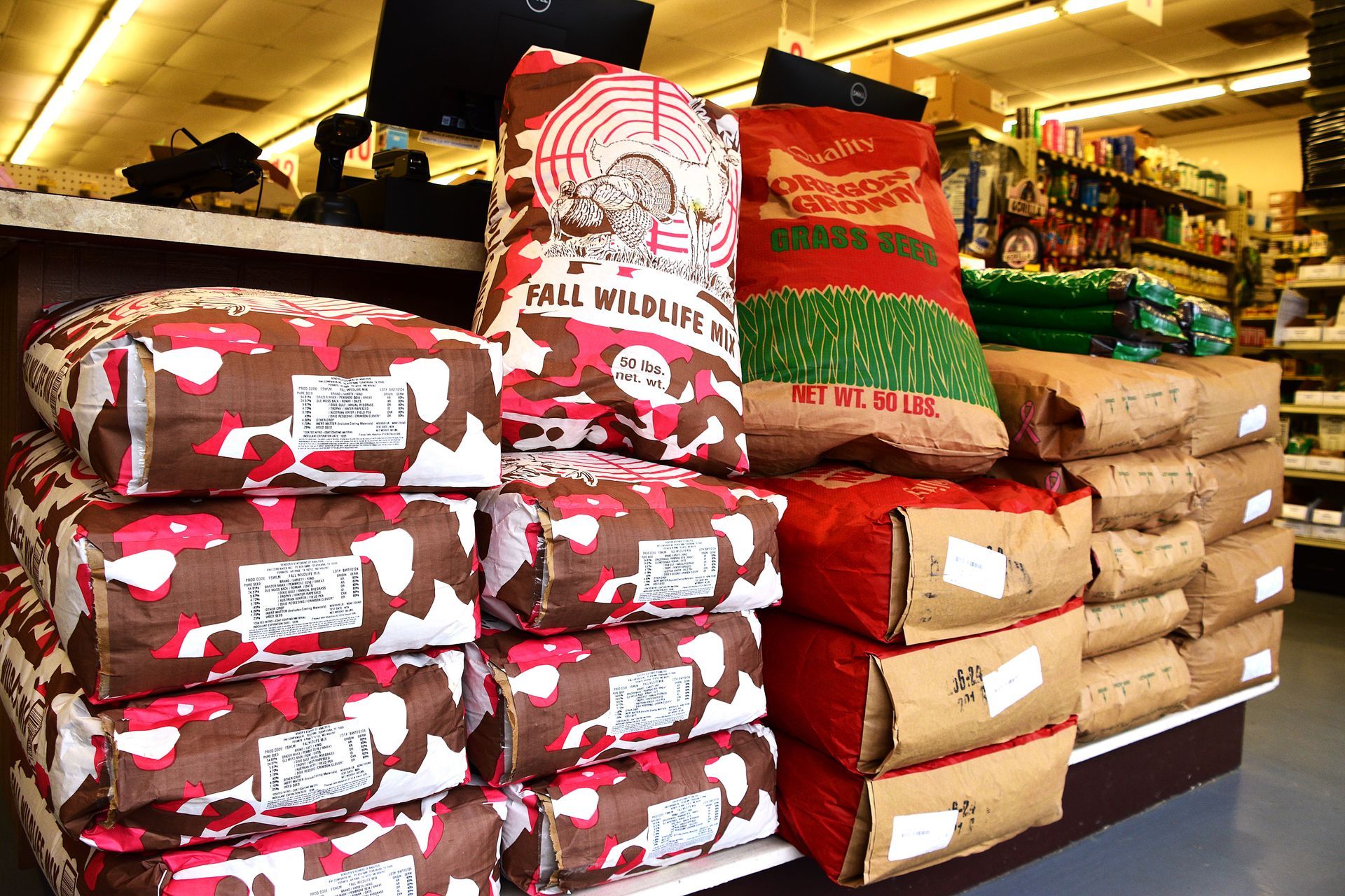 Stacks of bagged pet food on shelves in a store aisle