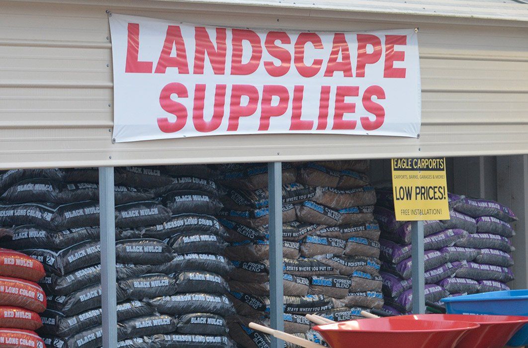 A store front with a sign that says landscape supplies