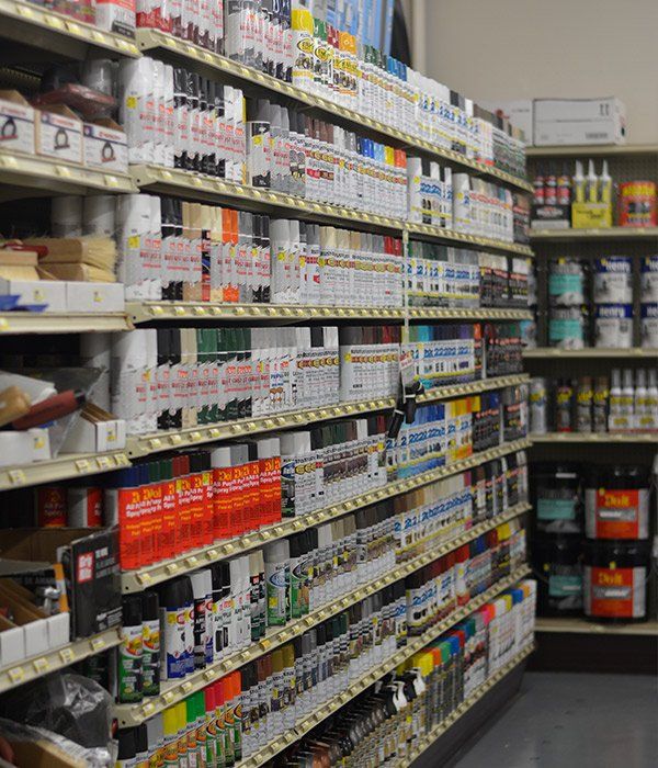 A store aisle filled with lots of products including spray paint