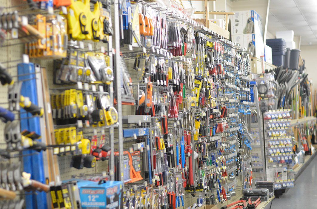 A row of shelves filled with lots of tools in a hardware store.