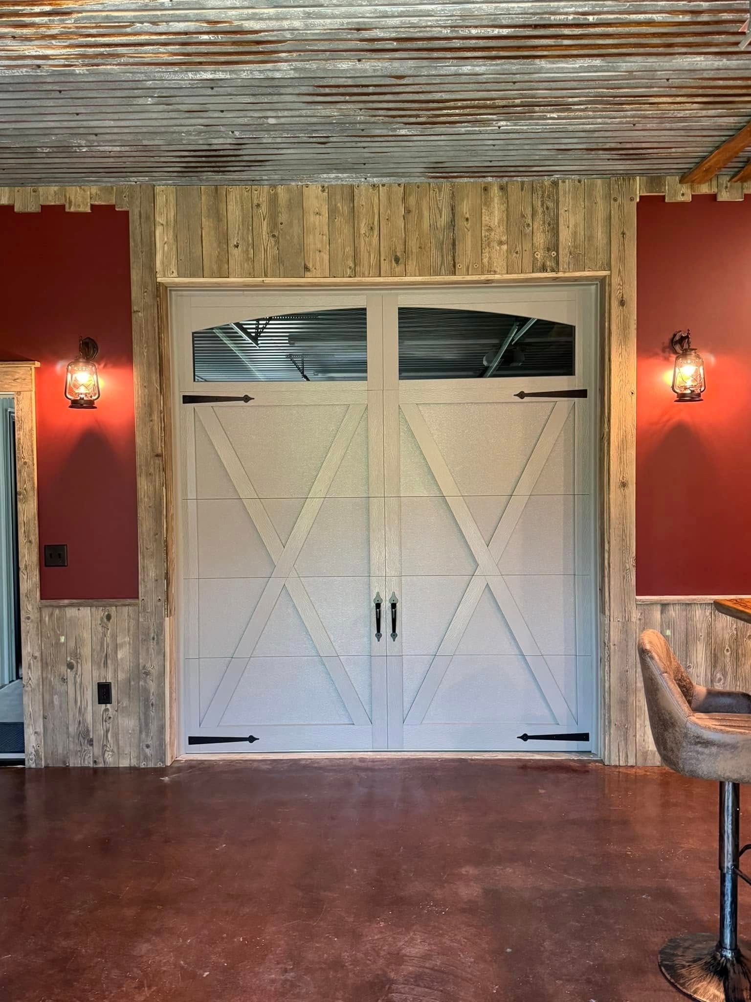 Rustic barn-style white double doors in a red-walled room with wood and stone accents.