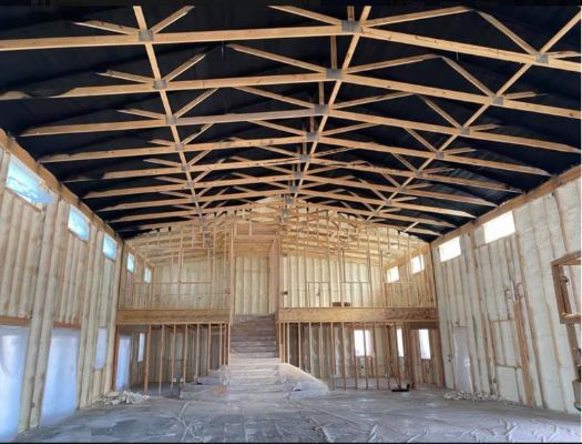 The inside of a building under construction with a large ceiling