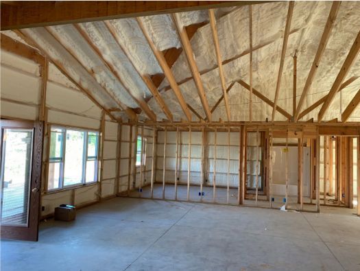 An empty room with a ceiling that is covered in insulation
