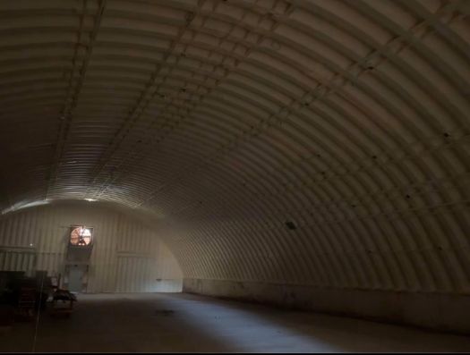 There is a clock on the wall in the middle of the tunnel.