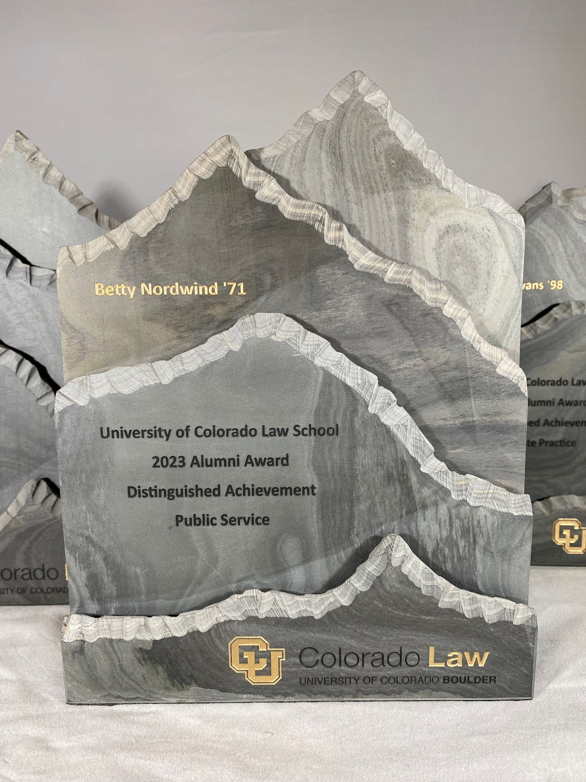 A trophy in the shape of a mountain is sitting on a table