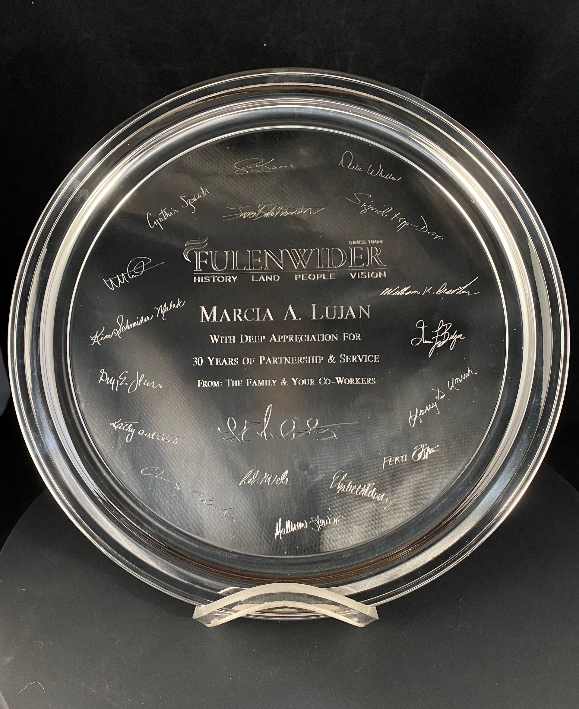 A silver plate with the name marcia written on it