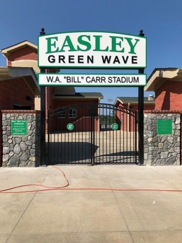 A sign that says easley green wave on it