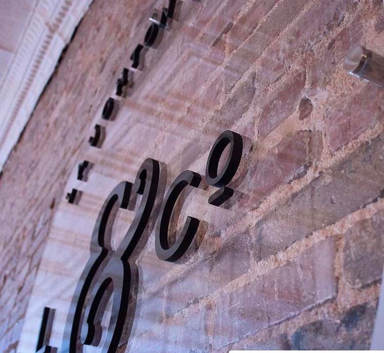 A brick wall with a sign that says cc2 on it