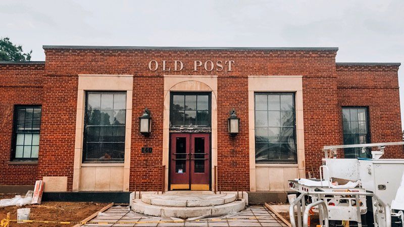 A red brick building with the word old post on it.