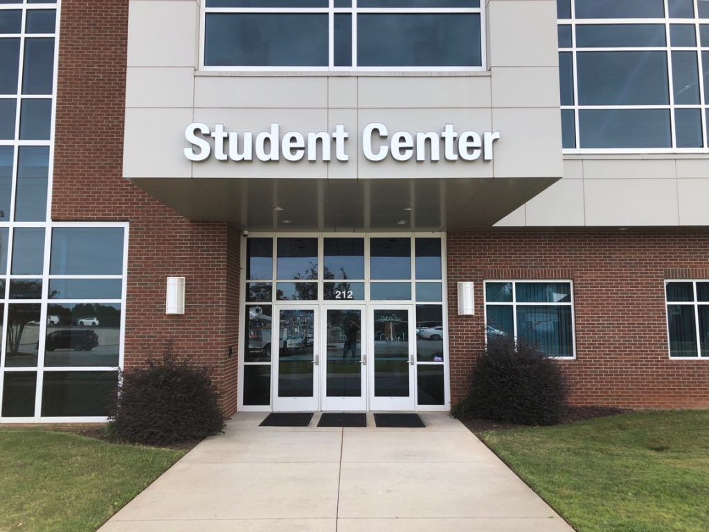 A large brick building with a sign that says student center