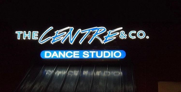 A neon sign for the centre & co. dance studio