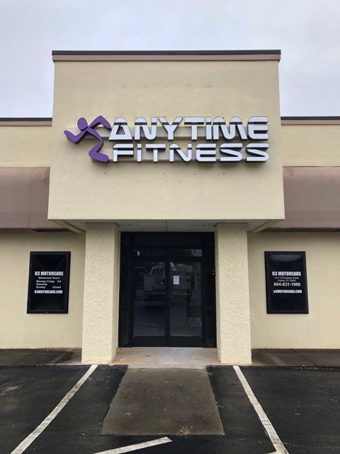 A building with a sign that says anytime fitness