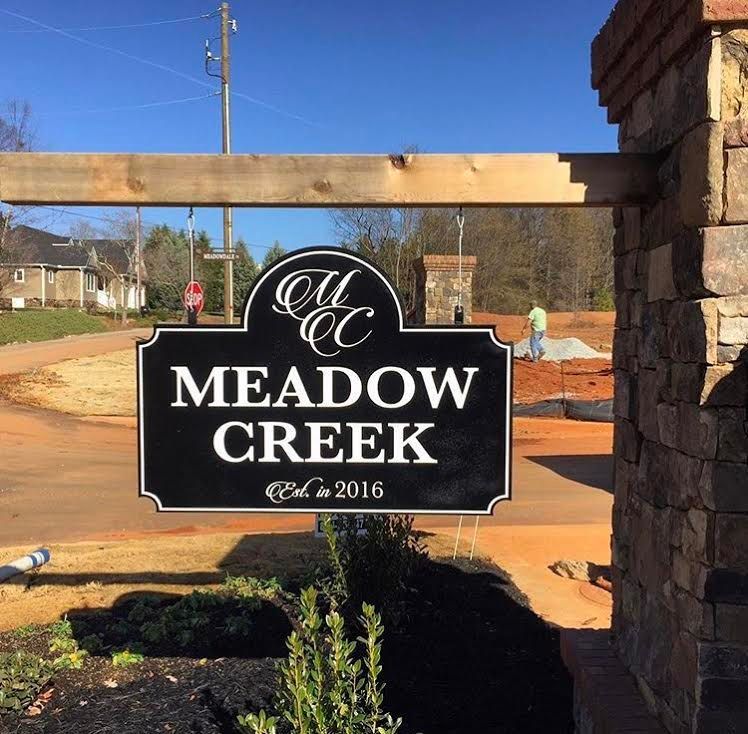 A sign that says meadow creek on it