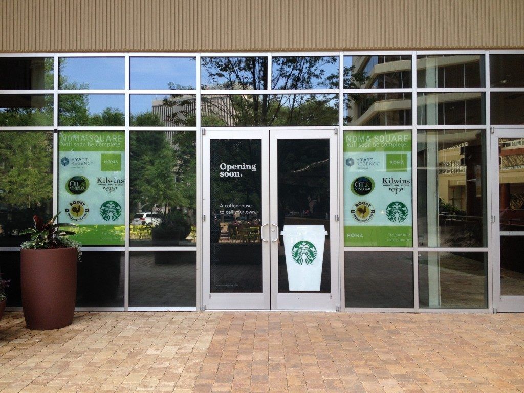 A store front with a starbucks sign on the door