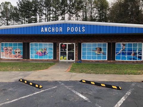 A building with a sign that says anchor pools on it