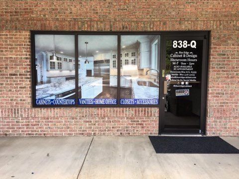 A brick building with a large window and a door.