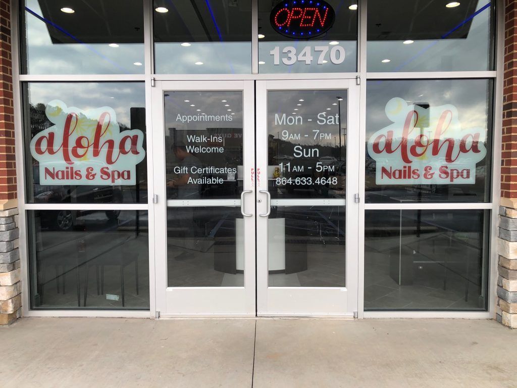 The front door of aloha nails and spa is open.