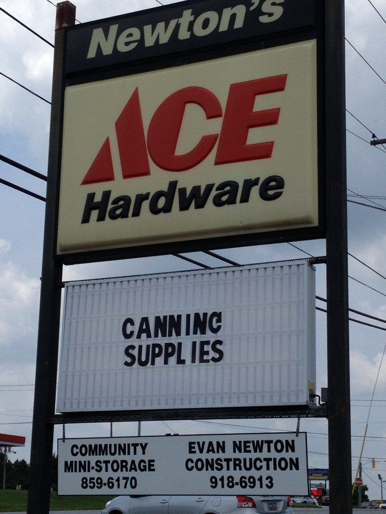 A sign for newton 's ace hardware and canning supplies