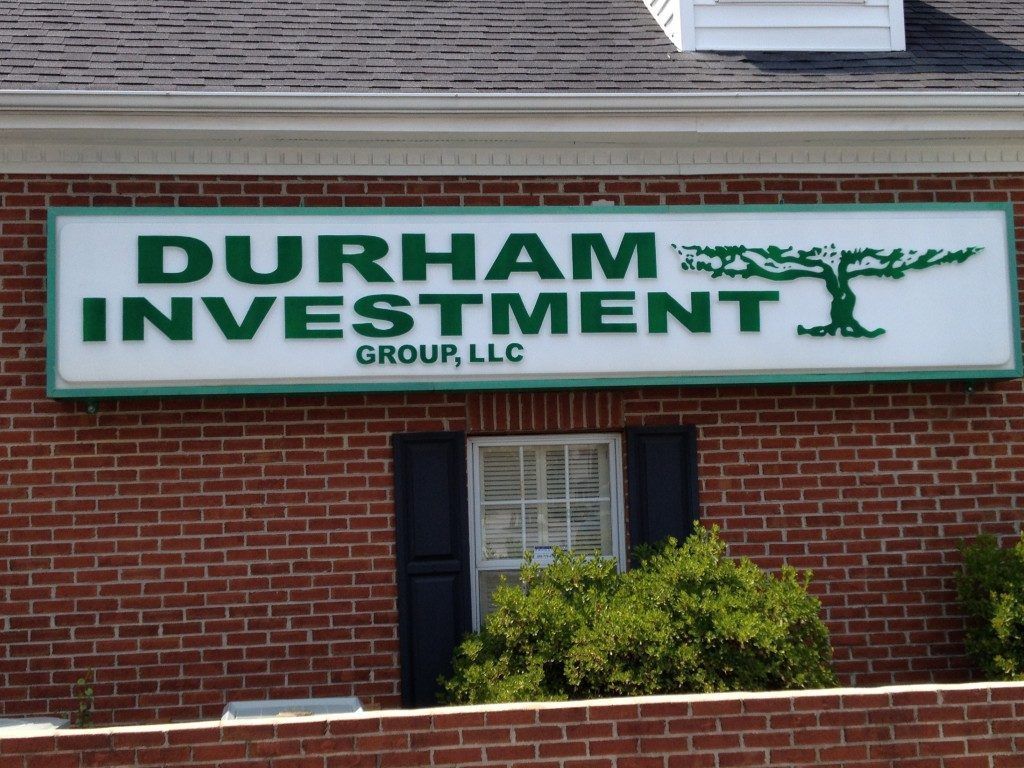 A brick building with a sign that says durham investment group llc