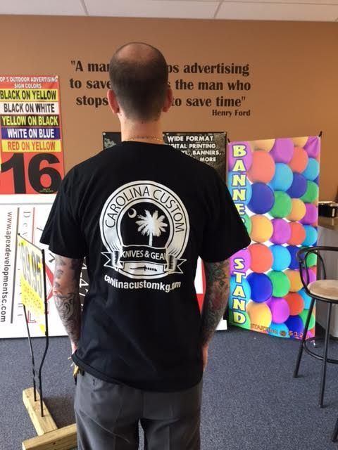 A man wearing a black carolina custom t-shirt