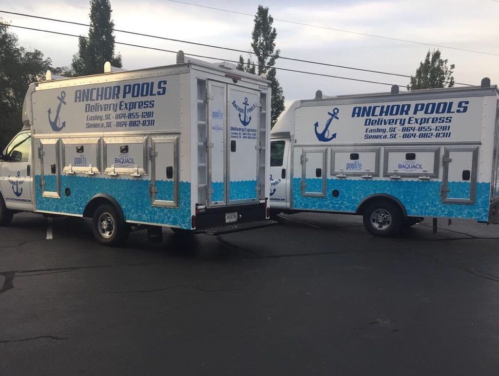 Two anchor pools trucks are parked next to each other