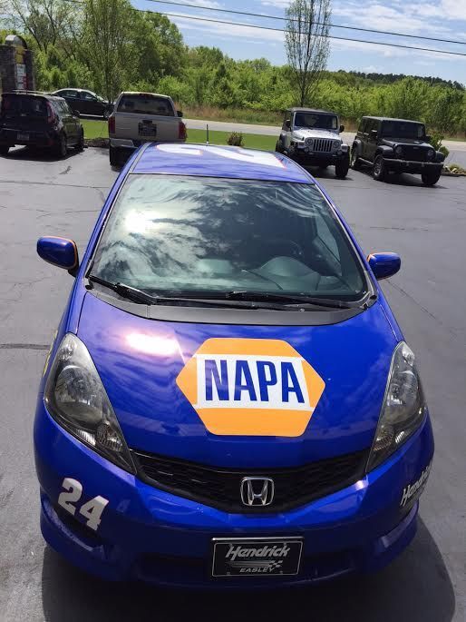 A blue napa car is parked in a parking lot