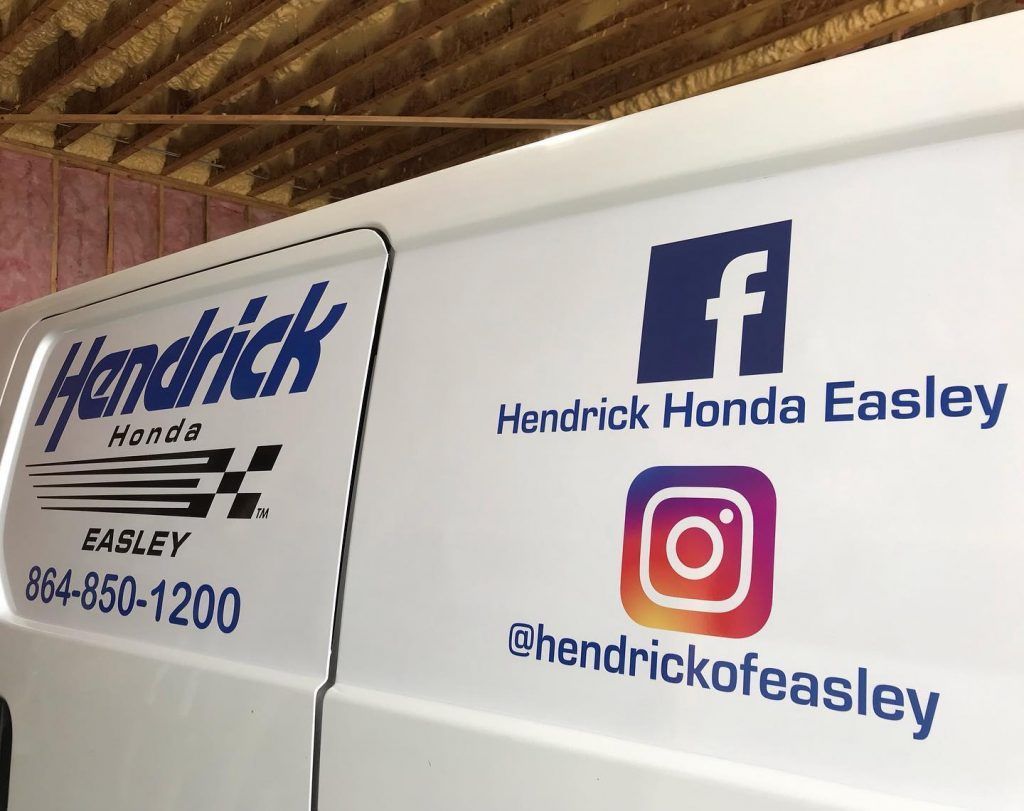 A white van with a facebook and instagram logo on it