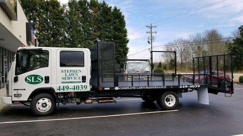 A stephen lock service tow truck is parked in a parking lot.