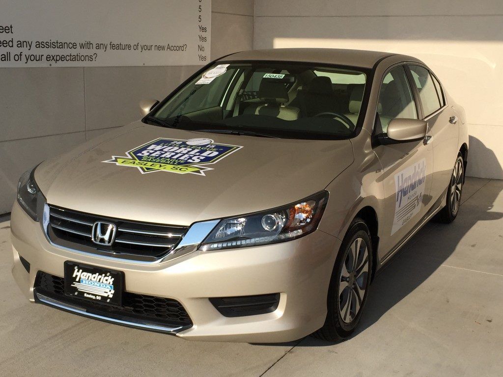 A honda accord is parked in front of a garage door