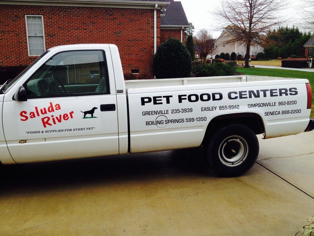 A white truck that says pet food centers on the side