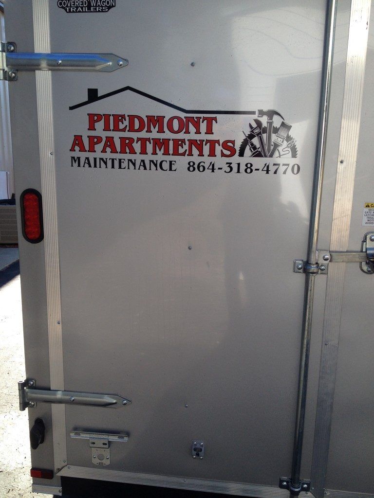 The back of a trailer that says piedmont apartments