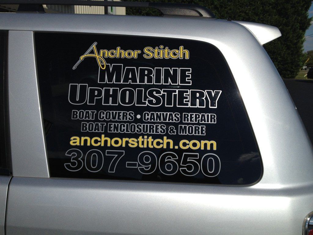 Another stitch marine upholstery is advertised on the side of a silver vehicle