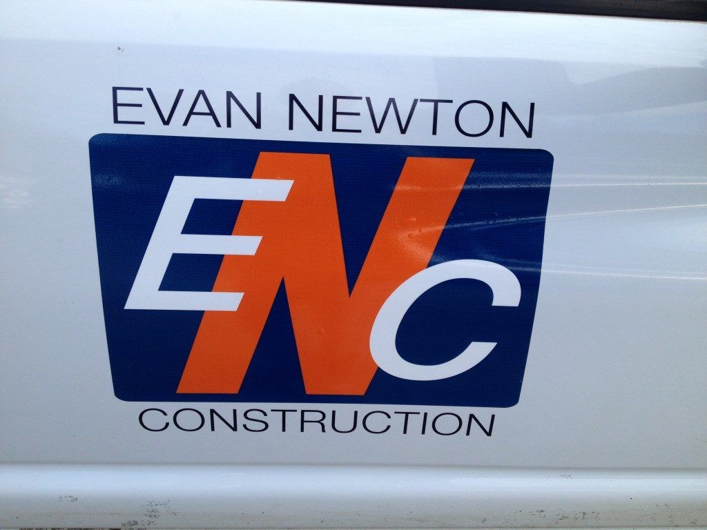 A white van with evan newton construction written on the side