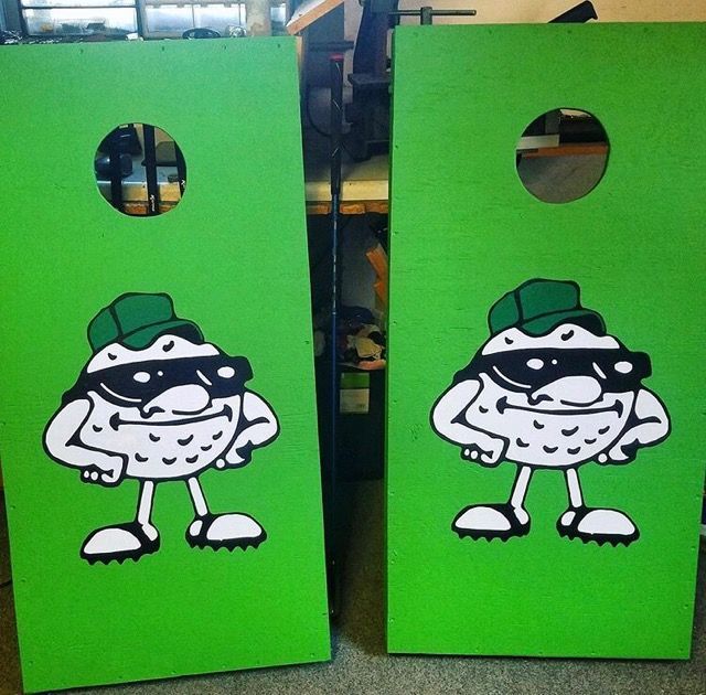 Two green boards with a cartoon character on them