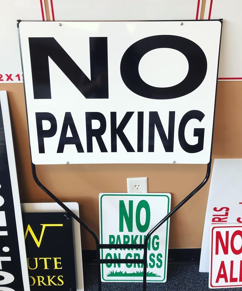 A no parking sign is surrounded by other signs
