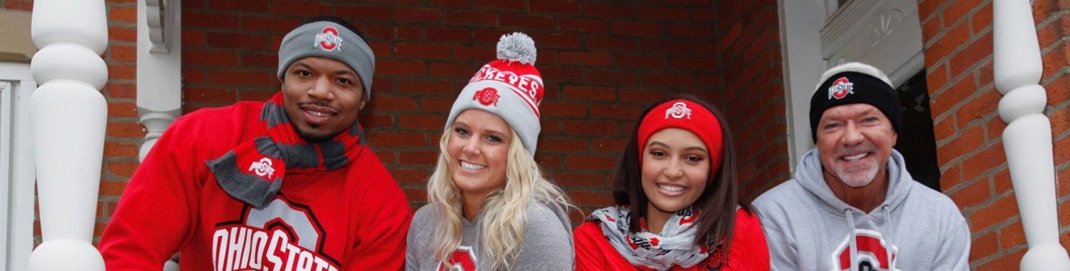 A group of people are posing for a picture on a porch.