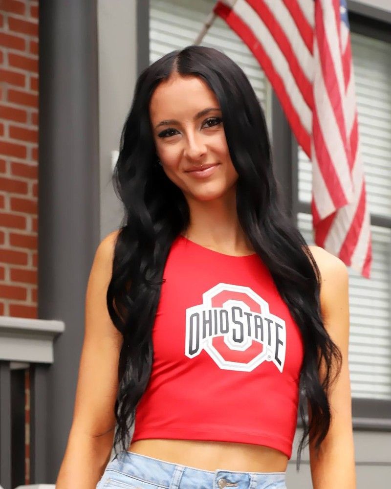 A woman wearing a red ohio state crop top