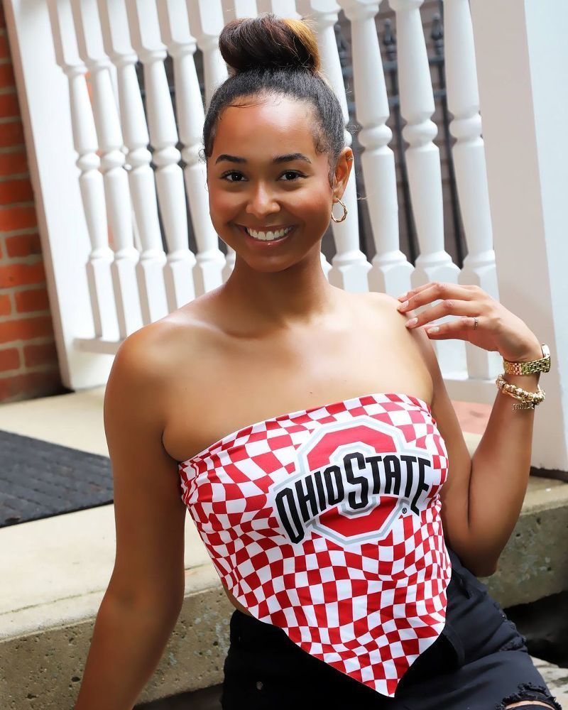 A woman wearing a red and white top that says ohio state
