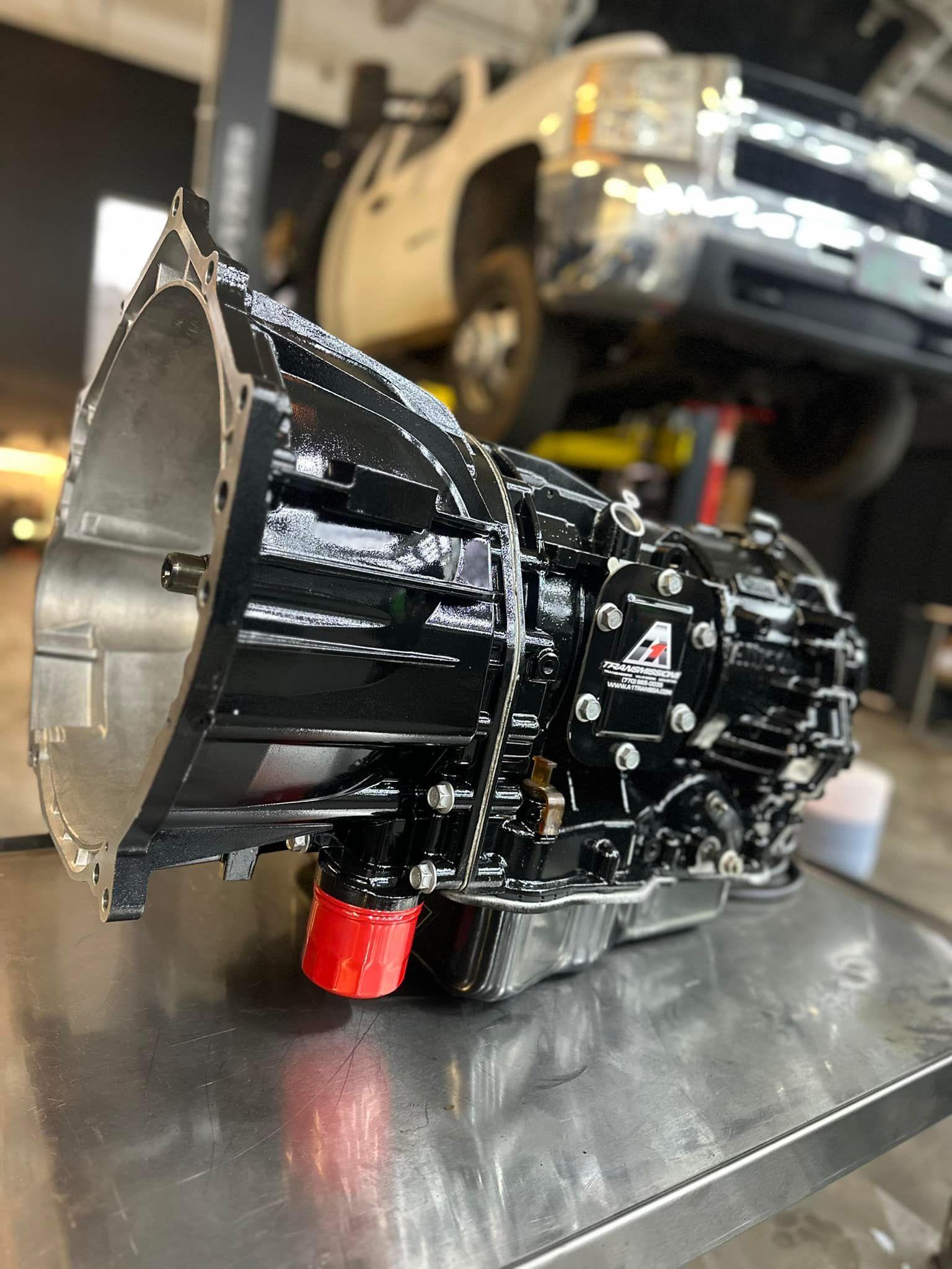 A black gearbox is sitting on top of a metal table.
