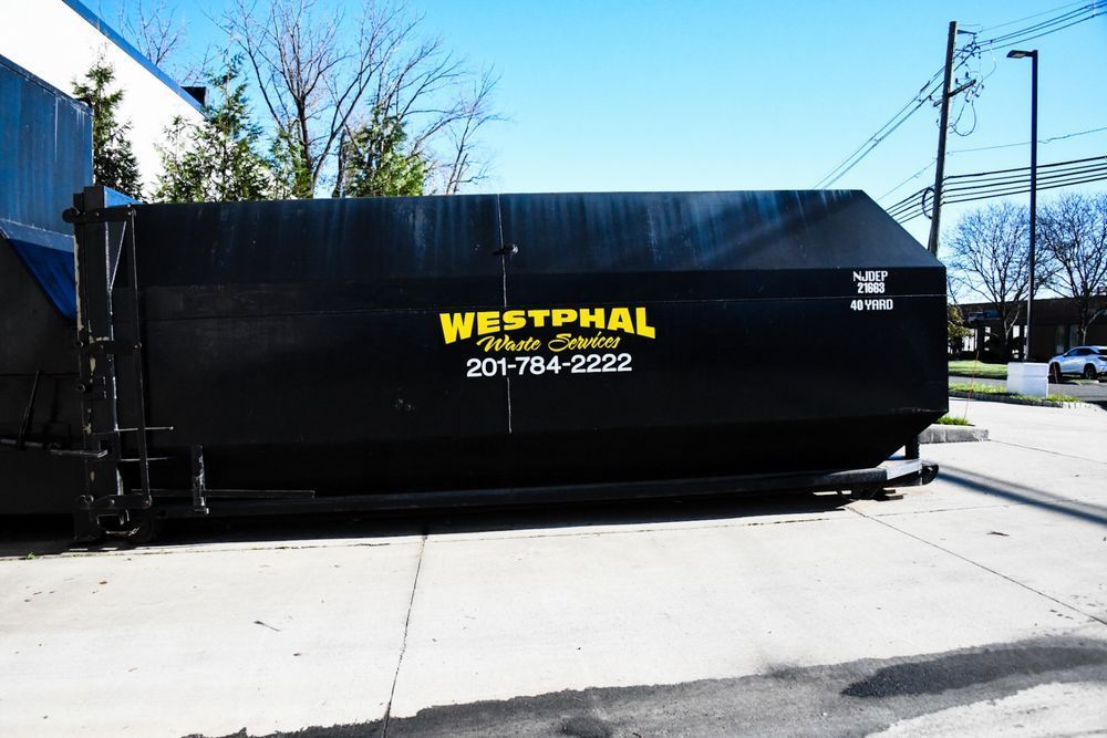 Black dumpster with yellow text 