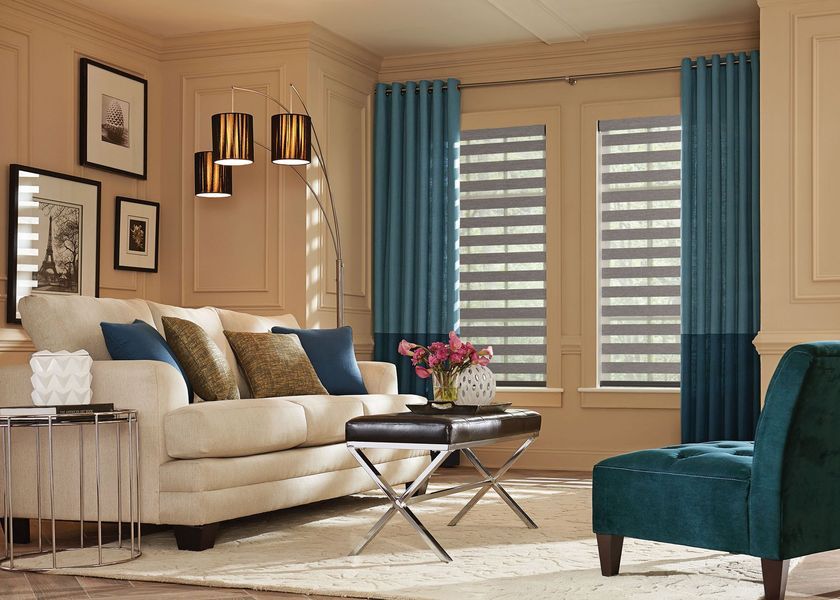 Living room with sofa, curtains, and modern blinds; teal and gold accents.