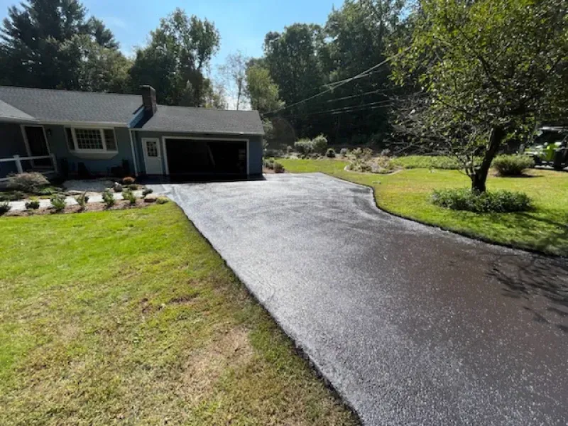 A driveway leading to a house with a golf cart parked in front of it