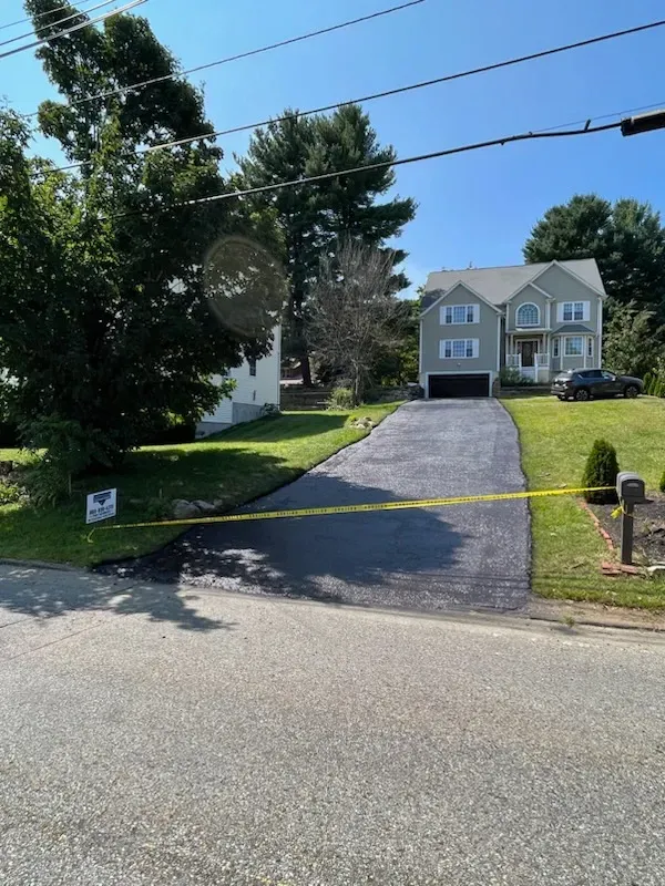 A house with a large driveway and a no parking sign