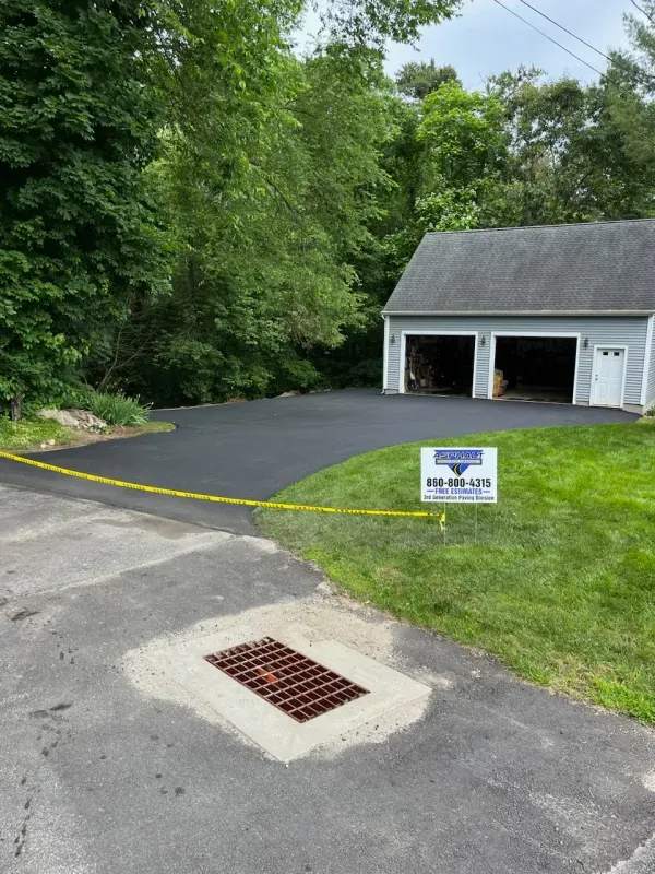 A driveway with a sign that says ' asphalt driveway ' on it