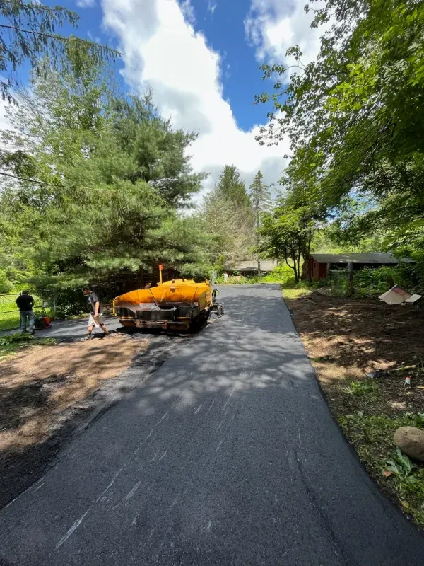 A yellow truck is parked on the side of a road
