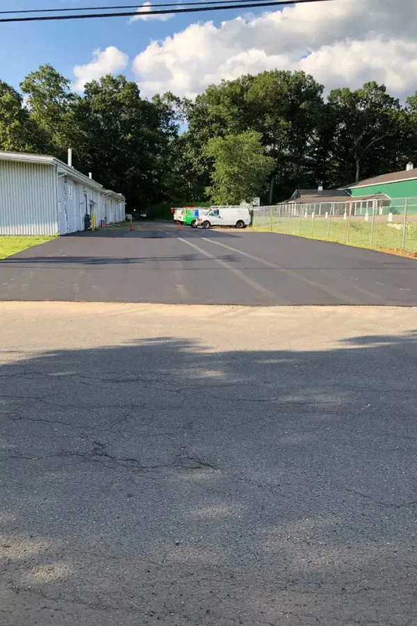 A truck is parked in a parking lot next to a building