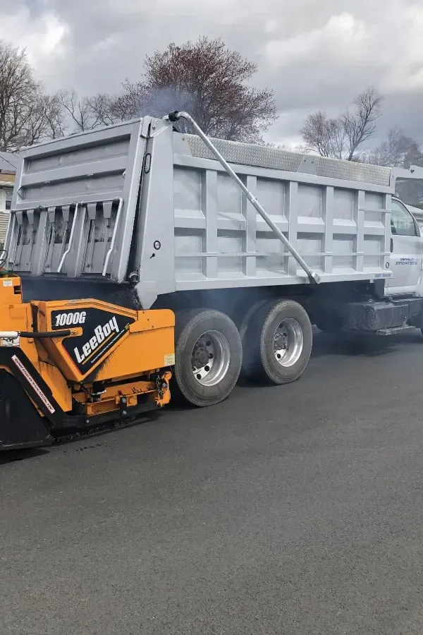 A dump truck is parked on the side of the road
