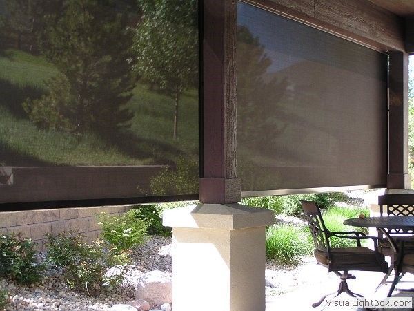 a shade in porch with a table and chairs