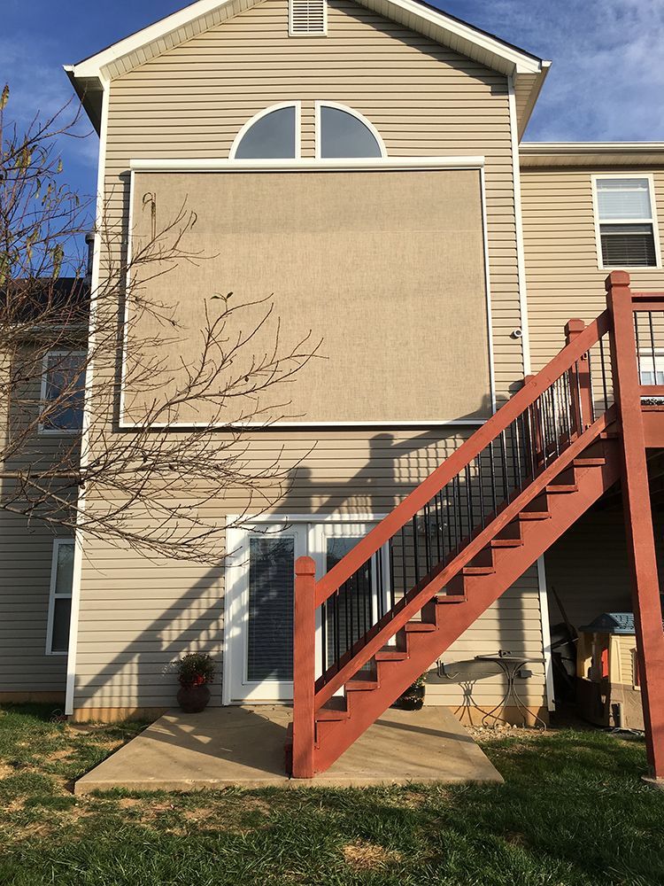 the back of a house with stairs leading up to it
